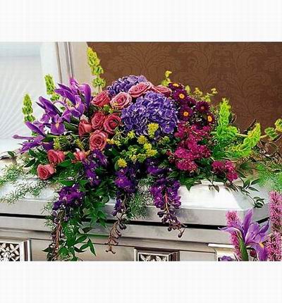 Arrangement of Roses, Hydrangeas, Iris, snap dragons and greenery fillers.