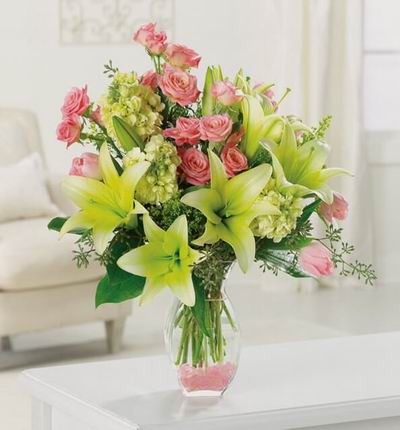 Floral mix of 6 buds of Lilies, 12 pink Roses, 3 pink Tulips, Stock and fillers.