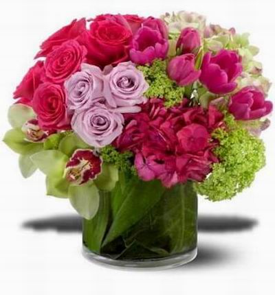 Orchids glossy tulips and hydrangea including vibrant hot pink lavender and chartreus.