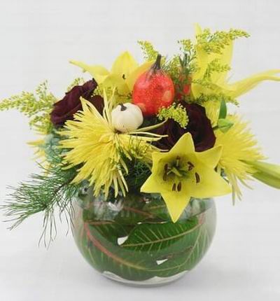 A tropical floral mix of Lilies, Spider Mums, Roses and fillers.