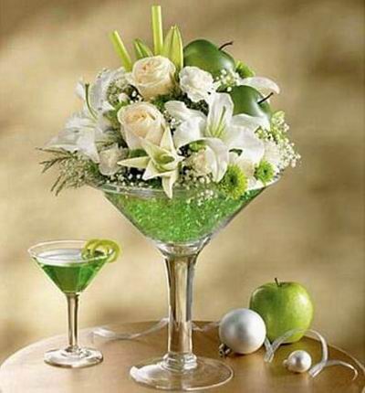 White lilies, roses and mini carnations, green button poms.