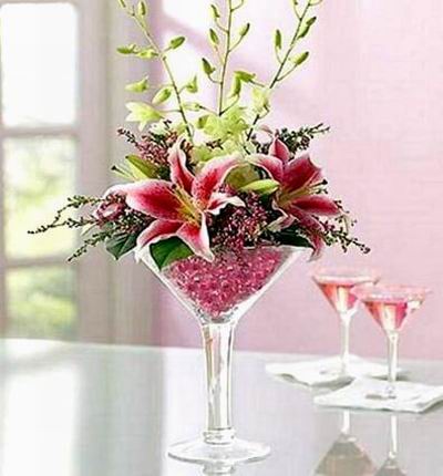 Fresh Dendrobium orchids, Stargazer lilies, heather and salal, beautifully designed by our select florists in an oversized martini glass.  (if martini glass is not available, a clear vase will be substituted)