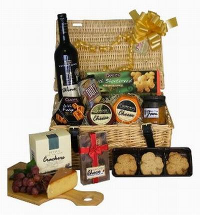 1 bottle of red wine, Cookies, two cheese blocks, fruit jam, crackers, Chocolates and biscuts.