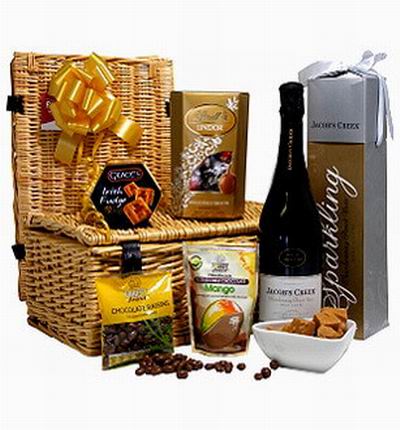 Sparkling Cider, Mango dried fruits, Biscut cookies, Lindor Chocolates and Chocolate Raisins. Sparkling Cider based on local selection. Brands will vary.  (Photo image is only an example)