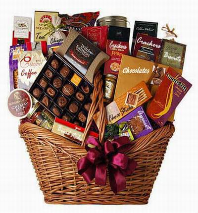 Basket with Assorted Chocolates, Chocolate sticks, Dried apricot, Salmon, cream Cheese, Godiva Chocolates, Mustard, Biscuts, Coffee beans, dried pasta noodles, Tea bags, bread sticks, crackers, fish crackers, Chips and Salsa.
