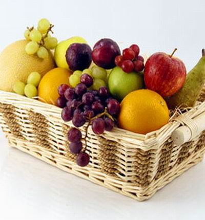 Fruit Basket platter of 2 oranges, 1 red apple, 1 green apple, melon, 2 plums, Finger grapes,  Globe grapes and small bottle of olive oil.