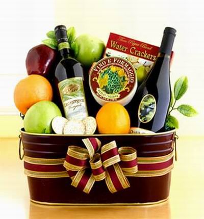 Fruit Basket of 2 oranges, 2 green Apples, 1 red Apple, Crackers, Cheese and two bottles of red Wine. Wine based on local wine selection. Brands will vary.  (Photo image is only an example)