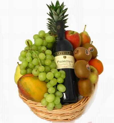 Fruit Basket of red Wine, Finger Grapes, 1 Mango, 2 Pears, 1 red Apple, 2 Oranges, 4 Kiwis and Pineapple. Wine based on local wine selection. Brands will vary.  (Photo image is only an example)
