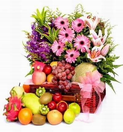 Flower basket of 6 pink Gerbera Daisies, 4 Lily buds, Orchids and fillers with Globe Grapes, 1 Cantaloupe, 2 red Apples, 2 green Apples, 4 Plums, 2 Kiwis, 3 Oranges, 2 Fuji Apple, 2 Dragon Fruits and 1 Mango. Basket may vary based on availability.