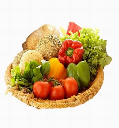 Basket of Vegetables and bread rolls.  1 red, 1 green, 1 yellow Bell Pepper, 5 Tomatoes, Green Salad Leaves and 4 Bread Rolls.
