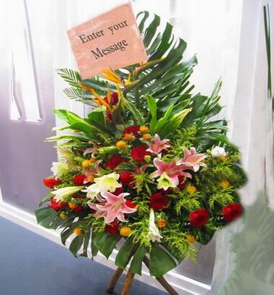 Flower Stand of Lilies, Roses, Ball Poms and Birds of Paradise flowers with large leaves (Substitutions may apply if a flower item is unavailable)