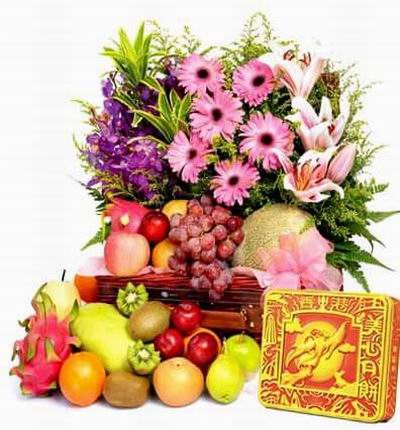 A box of Premium Mooncakes and a Flower basket of 6 pink Gerbera Daisies, 4 Lily buds, Orchids and fillers with Globe Grapes, 1 Cantaloupe, 2 red Apples, 2 green Apples, 4 Plums, 2 Kiwis, 3 Oranges, 2 Fuji Apple, 2 Dragon Fruits and 1 Mango. Basket may va