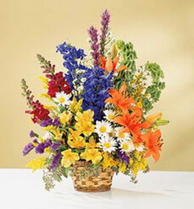 4 orange Lily buds, white Chrysanthemums, yellow Orchids, Stock, Hydrangea and Statices in basket