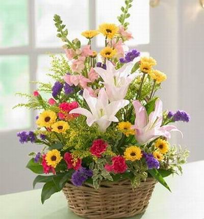 3 large pink Lily buds, yellow Chrysanthemums,red Carnations, Stock, Statices and green fillers in basket