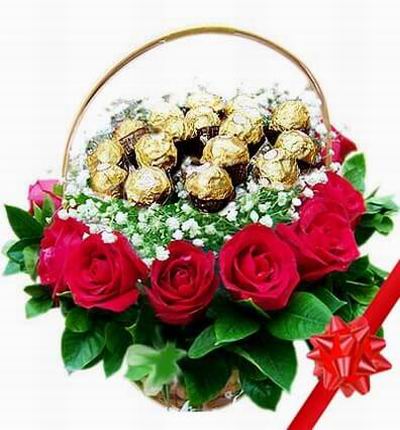 A flower basket of 15 Ferrero Chocolates surrounded by Baby's Breath, 6 red and 6 pink Roses and Leaves.