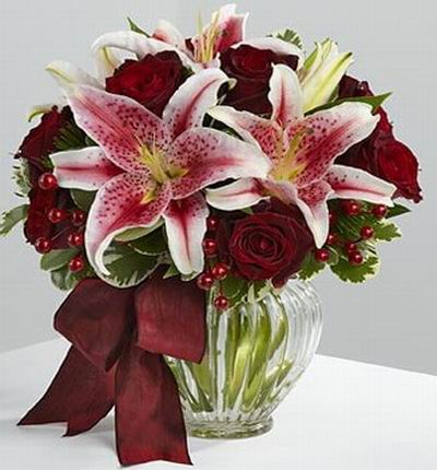 8 Dark red roses and 5 Stargazer lilies.