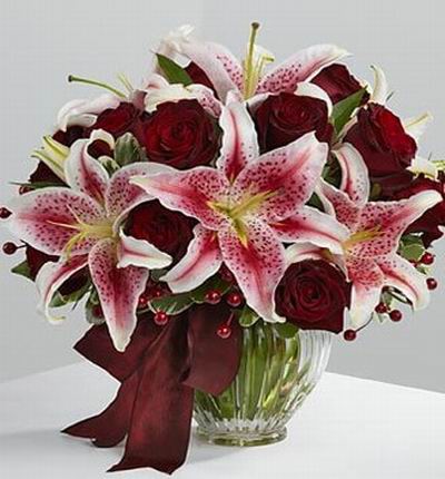 10 Dark red roses and 7 Stargazer lilies.