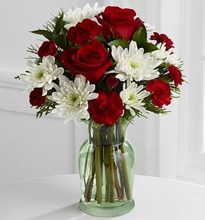 9 White chrysanthemums, 9 red mini carnations and holiday greens.