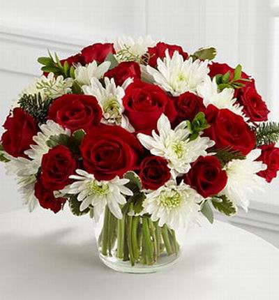18 Rich red roses with 15 white chrysanthemums, assorted Christmas greens and eucalyptus.