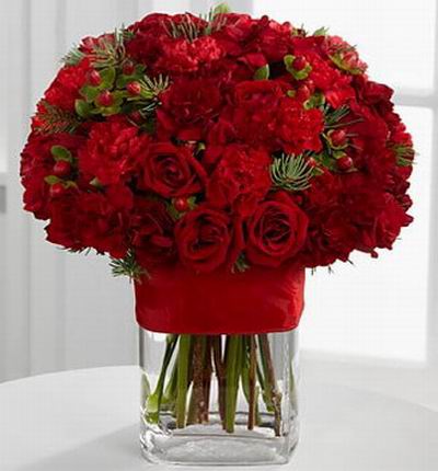 20 Bright red spray roses, 20 red mini carnations, red hypericum berries and assorted holiday greens.