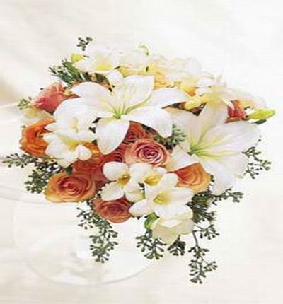8 champagne Roses, 2 white Lily buds and white Freeasias or Orchids mix display