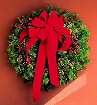 Christmas Flower Selection - Christmas wreath, hypericum berries, pines (flowers will replace pines if out of Stock).   Artificial and plastic materials are used.