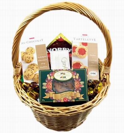 A basket of Chocolate Chips, Tart Cookies, Chocolates, Macadamia Gourmet Cake (or Chocolate cake), and Candies.