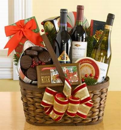 A basket of two bottles of Red wine, 1 Bottle of White Wine, Chocolate Mint Cookies, Belgium Milk Chocolate Candy Bar, Cheddar Cheese, box of thin Crackers and assorted Chocolates.