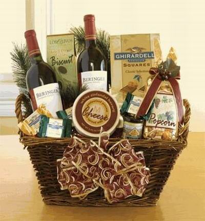A basket of 2 Red Wines, Ghirardelli Square Chocolates, Carmel Popcorn, Mustard, Cheese and Biscuits.