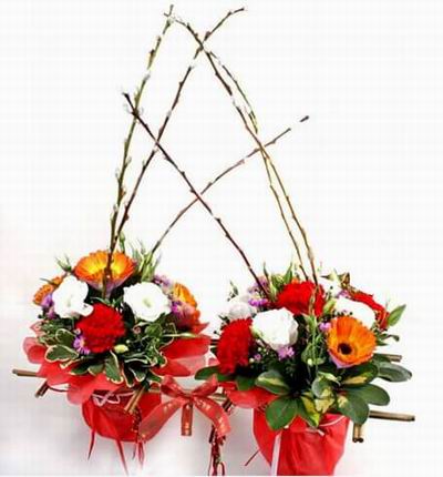 Two flower baskets of Carnations, Gerbera Daisies, Willows and greenery.