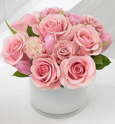 A pink mix of 6 roses, 4 carnations and 5 tulips and green leafs