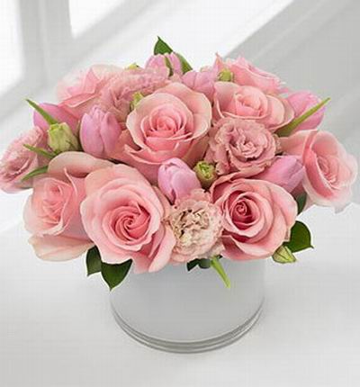 A pink mix of 8 roses, 4 carnations and 7 tulips and green leafs