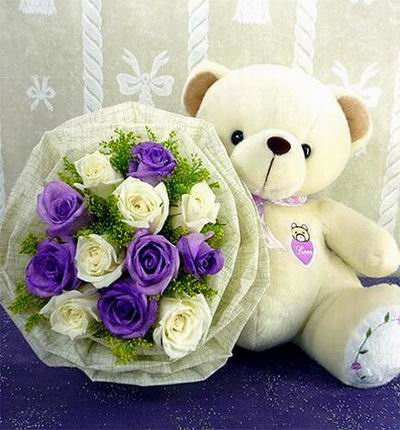 6 purle and 6 white roses with a 30cm teddy bear. Teddy bears may vary based on availability.