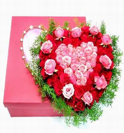 30 red Roses and 10 pink roses in the outer circle with 30 pink inner roses. Boxed in with green fillers.  If boxes are not available, a vase may be used for substitution.