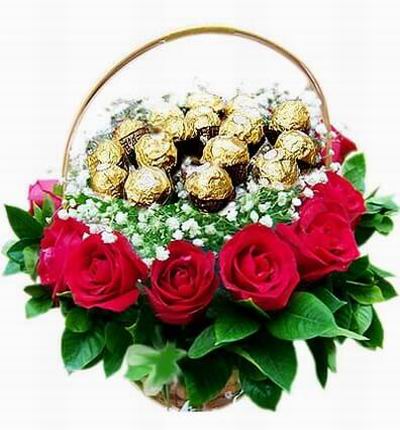 A flower basket of 16 Ferrero Chocolates on top of Baby's Breath, 12 red roses and leaves.