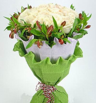 24 white Roses surrounded by flower greenery.