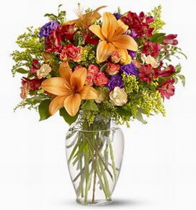 3 orange Lilies, and mix of Roses and greenery.