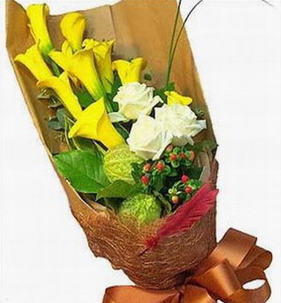 10 yellow Calla Lilies, 3 white Roses, Hypericum Berries and fillers.