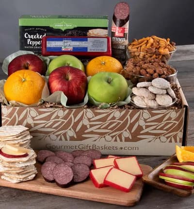 Delectable fruits - fresh from the farmer's market - are packed same day with snack mix, cookies, cheese, and crackers, to make your new favorite gift basket! This delicious assortment is sure to amaze. It's also perfectly balanced to suit all tastes.

Includes:
* Fresh Fruits - Apples & Oranges - 6 ct.
* Key Lime Cookies - 2.25 oz.
* Classic Vermont Sharp Cheddar Cheese - 8 oz.
* Sea Salt & Cracked Peppercorn Water Crackers - 4 oz.
* Chichester Crunch Snack Mix - 5 oz.
* Butter Toffee Peanuts - 5 oz.
* Summer Sausage - 5 oz.