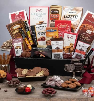 We've compiled the most extravagant chocolate gift yet! A luxury sampling of every chocolate treat you could possibly imagine is ready for next day delivery to your lucky recipient. From chocolate covered potato chips to mudpuppies, chocolate bars and truffles, cookies and wafer rolls, chocolate covered cherries and espresso beans, the perfect chocolate lover's basket is here!

Includes:
* Chocolate Wafer Rolls - 4.4 oz.
* Chocolate Chip Cookies - 4 oz.
* Chocolate Cubetti Wafer Cookie Bag - 8.8 oz.
* Mudpuppies - 5.5 oz.
* Dark Chocolate Cookie Thins - 4.6 oz.
* Assorted Truffles - 5.1 oz.
* Red Velvet Cookies - 5.5 oz.
* Peanut Butter Chocolate Chip Cookies - 2 oz.
* French Chocolate Truffles - 3.5 oz.
* Milk Chocolate Truffle Filled Bar - 3.5 oz.
* Belgian Chocolates - 1.76 oz.
* Milk Chocolate Sea Salt Caramels - 1 oz.
* Single Serve Chocolate Expresso Beans - 1.76 oz.
* Chocolate Caramel Grahams - 2.6 oz.
* Chocolate Covered Cherries - 2.3 oz.
* Caramel filled Milk Chocolate Squares - 5.32 oz.
* Salted Caramel Bar - 1.4 oz.
* Cookies & Cream Bar - 1.4 oz.
* Dark Chocolate Bar 3.5 oz.
* Gift Basket