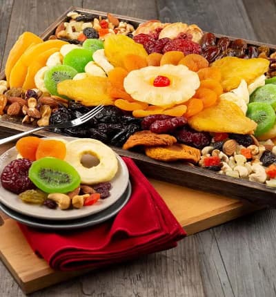 It's never a good idea to show up empty handed, and this eye-catching Fruit and Nut Party Platter is the perfect accompaniment for any occasion! Classic dried fruits like dates and cherries are paired with unique kiwi, apple rings, peaches, mango slices, and more. To top it all off, the corners contain crunchy delicious trail mix and roasted nuts.

Includes:
* Dried Apple Rings
* California Angelino Plums
* California Peaches
* California Prunes
* Glacé Cherry
* Dried Kiwi Slices
* Dried Mango Slices
* Pineapple Rings
* Sun-Dried California Dates
* Fruit & Nut Medley
* Natural Trail Mix
* Certified Kosher
* 14