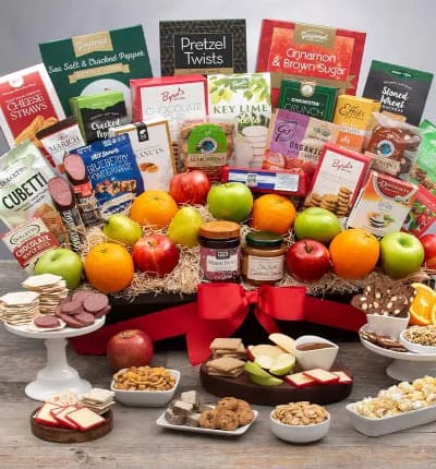 Our most extravagant gift basket yet, the Ultimate Fruit and Gourmet Gift is perfect for all gatherings, formal or informal. From family get togethers to corporate events, this spread is a thoughtful, luxurious way to complete the day. Sure to please all tastes, this luxury spread includes everything from cheese and crackers, to cookies and candies, popcorn and nuts, pretzels and trail mix, hard candies, chocolate covered cherries, and so much more!

Includes:
* Hazelnut Cubetti Wafer Cookie Bag - 8.8 oz.
* Almonduo Almondina Biscuits - 4 oz.
* Blood Orange Organic Hard Candies - 3.5 oz.
* Chocolate Covered Cherries - 2.3 oz.
* Almond Cashew Clusters with Pumpkin Seeds - 1 oz.
* Blueberry Pomegranate Trail Mix Crunch - 1 oz.
* Key Lime Cookies - 2.25 oz.
* Cinnamon & Brown Sugar Kettle Corn - 4.2 oz.
* Sea Salt & Cracked Pepper Kettle Corn - 4 oz.
* Classic Mini Pretzel Twists - 3 oz.
* Roasted & Salted Peanuts - 2 oz.
* Chichester Crunch - 2 oz.
* Chocolate Wafer Petites - 0.7 oz.
* Chocolate Chip Cookies - 4 oz.
* Key Lime Cookies - 4 oz.
* Peanut Butter Chocolate Chip Cookies - 2 oz.
* Almond Nougat - 4 oz.
* Cherry Buds Hard Candies - 1.75 oz.
* Garlic Sausage - 5 oz.
* Sea Salt Caramel Sauce - 12.25 oz.
* Summer Sausage - 5 oz.
* Choconut Almondina Biscuits - 4 oz.
* Oatcake Biscuits - 7.2 oz.
* Cheese Straws - 4 oz.
* 4 Red Apples
* 4 Green Apples
* 4 Oranges
* 3 Pears
* Assorted Citrus Slices - 5pc
* Keepsake Gift Basket