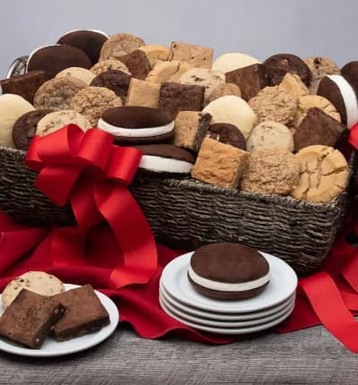 This ultimate basket of baked goods is perfect to please everyone in sight! Scrumptious whoopie pies, sweet and savory cookies, and decadent fudgy brownies in a variety of flavors are the perfect pairing for a momentous occasion.

Includes:
* Fudge Walnut Brownie
* 2 Chocolate Chunk Brownies
* 2 Peanut Butter Brownies
* 2 Chocolate Chip Blondies
* Butterscotch Blondie
* 2 White Chocolate Chip Macadamia Blondies
* 2 Oatmeal Raisin Cookies
* 2 Peanut Butter Cookies
* 2 Chocolate Chip Cookies
* 2 Fudge Brownie Cookies
* 2 Lemon Sugar Cookies
* 2 Pecan Sandy Cookies
* 6 Whoopie Pies
* Keepsake Gift Basket