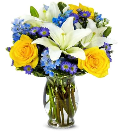 * White Asiatic Lilies
* Yellow Roses
* Blue Delphinium
* Purple Monte Casino
* Keepsake Glass Vase