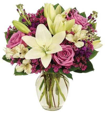 * White Asiatic Lilies
* Purple Roses
* White Alstroemeria
* Purple Waxflower
* Clear Vase