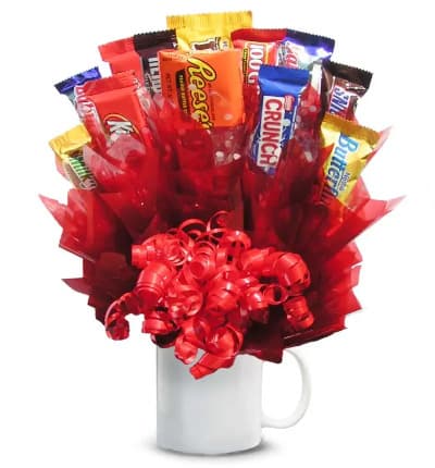 Show someone special how sweet you are with this amazing candy bouquet. All your favorite candies are arranged in an impressive display within a keepsake mug. This is a unique and tasty gift that is sure to make their day.

Includes:
* Variety of Candy
* Reusable Mug
* Decorative Bow