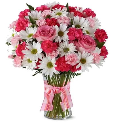 * Hot Pink Spray Roses
* White Traditional Daisies
* Pink Mini Carnations
* Clear Vase with Pink Bow