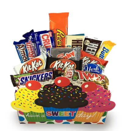 Send wishes to a chocolate lover in your life with this gift full of the most popular chocolate candy bars! They'll indulge in sweetness for their big day and have you to thank! This gift basket includes: This basket includes Almond Joy, Baby Ruth, Nestle Crunch, Peanut Butter Cups, Hershey Bars, Butterfingers, York Peppermint Patty, Kit Kat, Twix, Snickers & Chunky Bars.

Includes:
* Assortment of Chocolate Candy Bars
* Cupcake Container