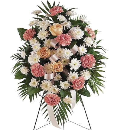 The Pastel Floral Sympathy Standing Spray is a beautiful funeral gift to send in memorial of someone who has passed. Created with seasonal pastel flowers including carnations, Chrysanthemums and roses. The flowers are arranged in an oval shaped on a standing spray design to be placed in a funeral home during a service.

Includes:
* Pink Carnations
* White Spray Chrysanthemums
* Seasonal Roses
* Decorative Pink Ribbon
* Sympathy Stand