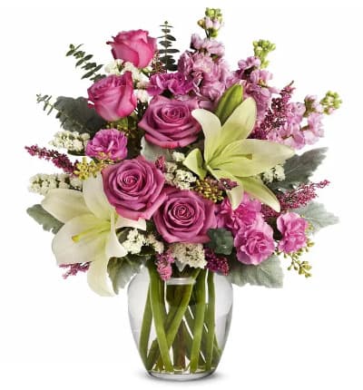 * Lavender Roses
* White Asiatic Lilies
* Mini Pink Carnations
* Pink Stock
* White Sinuata Statice
* Lavender Heather
* Seeded Eucalyptus
* Dusty Miller
* Spiral Eucalyptus
* Glass Vase